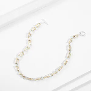 Detailed view of high-quality two-tone gold and silver U-link chain necklace with OT clasp