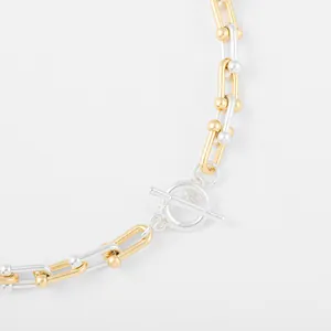 Close-up detail of two-tone industrial style link chain necklace with T-bar closure