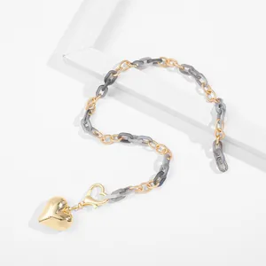 Detailed view of a gold heart pendant necklace with grey marble acrylic chain links.