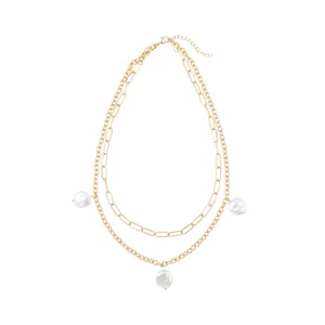 Detailed view of dual-layer gold chain necklace featuring three elegant white pearls.
