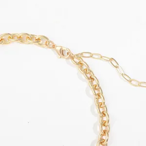 Close-up detail of a gold chunky hip-hop chain necklace showing lobster clasp