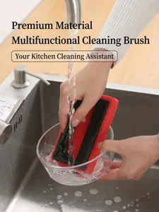 Close-up of a kitchen sponge cleaning brush with handle being used to wash a glass bowl