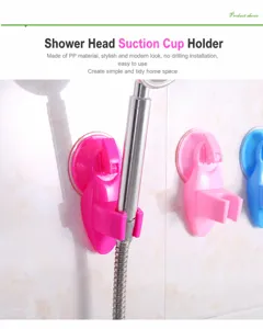 Macro view showing a pink plastic suction cup shower head holder fixed on bathroom tiles