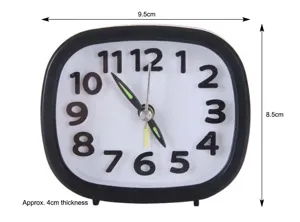 Detail showing black analog alarm clock with dimensions 9.5x8.5 cm and 4 cm thickness