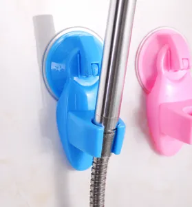 Detail view of durable blue PP plastic suction cup shower head holder installed on wall