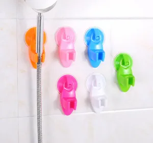 Detail view of colorful suction cup shower head holders mounted on bathroom tile