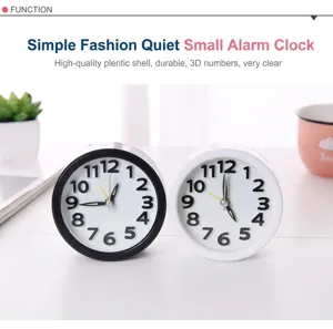 Detailed close-up of round black and white silent alarm clocks with night light.