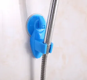 Detail view of a blue suction cup shower bracket mounted on a bathroom tile wall.