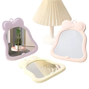 Cute bow-shaped desktop makeup mirrors in pastel colors for dorm decor.