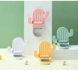 Cactus-shaped wall-mounted mop and broom holders in four pastel colors for home organization
