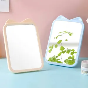 Minimalist cat ear makeup mirror with a foldable stand for cute desktop vanity setups