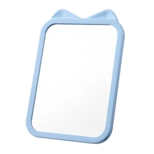 Cute light blue cat ear makeup mirror with foldable desktop stand for dormitory use.