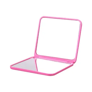 Tragbarer rosa doppelseitiger Klapp-Kosmetikspiegel für das professionelle tägliche Make-up.