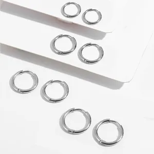 Detail view of various sizes of stainless steel hoop earrings on white display cards