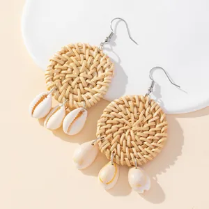 Handmade circular rattan drop earrings with natural white shell pendants for boho style