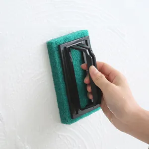 Green scouring pad cleaning brush with black handle for bathroom wall cleaning