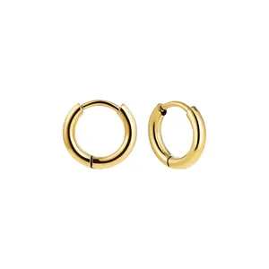 Detailed macro view of polished gold stainless steel hoop earrings for a sleek look