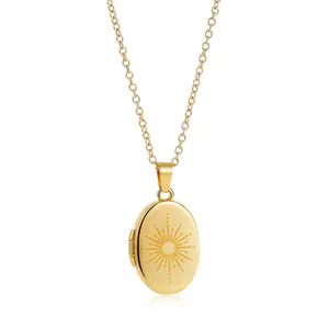 Detailed view of a vintage gold oval locket necklace featuring a sunburst engraving.