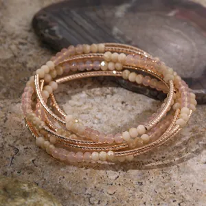 Close-up of multi-layer bracelet with rose gold textured metal and soft pink faceted crystal beads