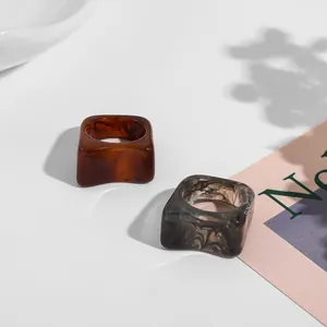 Close-up detail of trendy square acrylic rings featuring marbled and tortoiseshell patterns