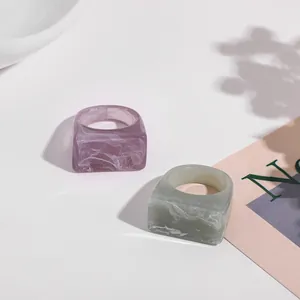 Close-up detail of elegant purple and green marble texture acrylic square rings set