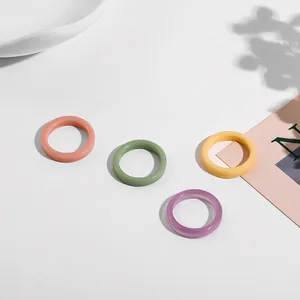 Close-up of colorful minimalist acrylic ring set featuring smooth glossy finish.