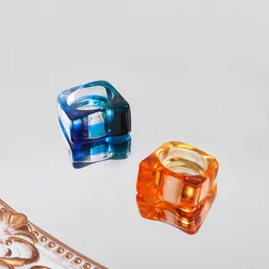 Close-up of chunky square acrylic rings with vibrant blue and orange translucency