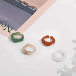 Detailed view of stylish acrylic resin rings set featuring various marbled colors