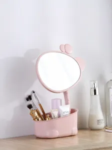 Primer plano del espejo de maquillaje en forma de jirafa rosa con base de almacenamiento