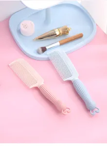 Pair of cute pastel cartoon rabbit head plastic hair combs displayed on a pink vanity table.