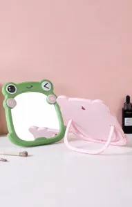 Close-up detail of the cute frog-shaped makeup mirror with a foldable hidden stand
