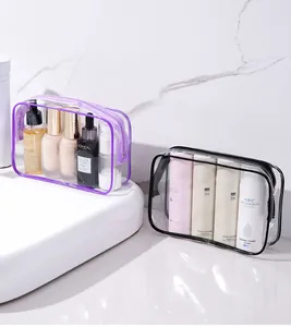 Detailed view of two transparent PVC waterproof cosmetic bags with zippers in a bathroom