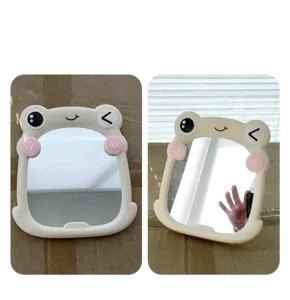 Detail shot showing the real-life appearance of a cute frog-shaped plastic makeup mirror