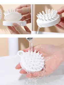 Detailed close-up of white silicone scalp brush showing detachable parts and water rinse