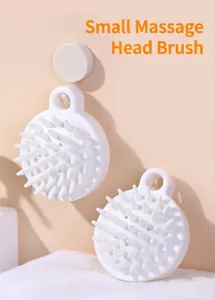 Close-up of white silicone scalp massage brush hanging on a wall hook for hair washing