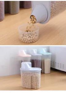 Detail showing soybeans poured from a transparent plastic storage container into a small cup.