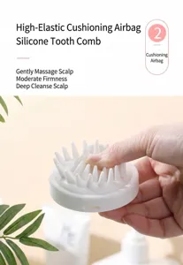 Detail view of flexible silicone teeth on white scalp massage and hair wash brush