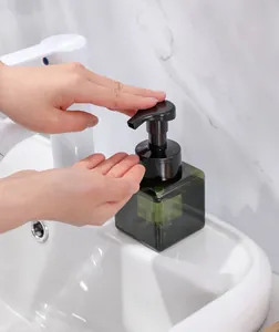 Detailed view of a dark green square foaming pump dispenser bottle for face wash