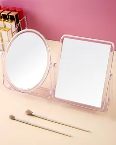 Macro view of transparent rotatable desktop makeup mirror with oval and square frames