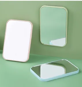Portable plastic desktop makeup mirrors in pastel colors shown in various positions