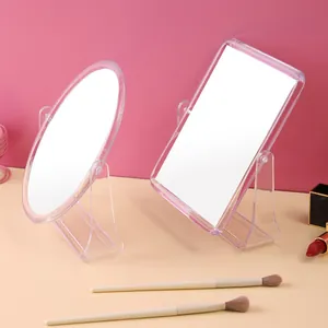 Clear acrylic double-sided rotating vanity mirror in oval and square shapes