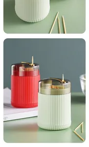 Macro view showing details of automatic press-type toothpick boxes in red and green