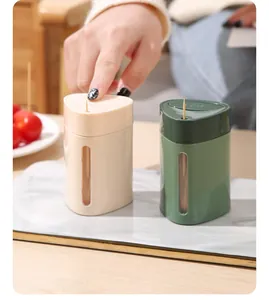 Close-up of automatic press-type plastic toothpick holder for dining room and home