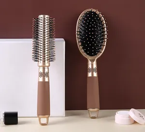 Set of two professional champagne gold hair brushes for styling and scalp massage
