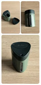 Detail view of green plastic press-type toothpick box with push lid and window