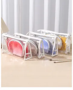 Macro view of four colorful 3-piece portable waterproof toiletry bag sets on a table.