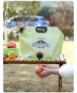 Portable 8L food grade outdoor water storage bag being used at a campsite table
