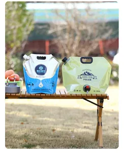 Portable 5L and 8L outdoor water bags displayed on a wooden table for camping use.