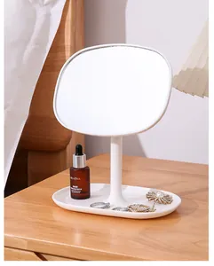 Elegant white desktop vanity mirror with integrated jewelry tray on wooden table
