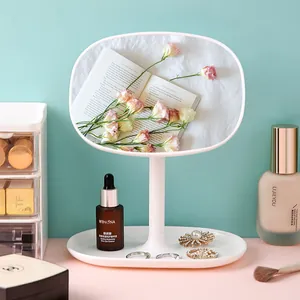 Minimalist white desktop makeup mirror with rotatable oval head and storage base